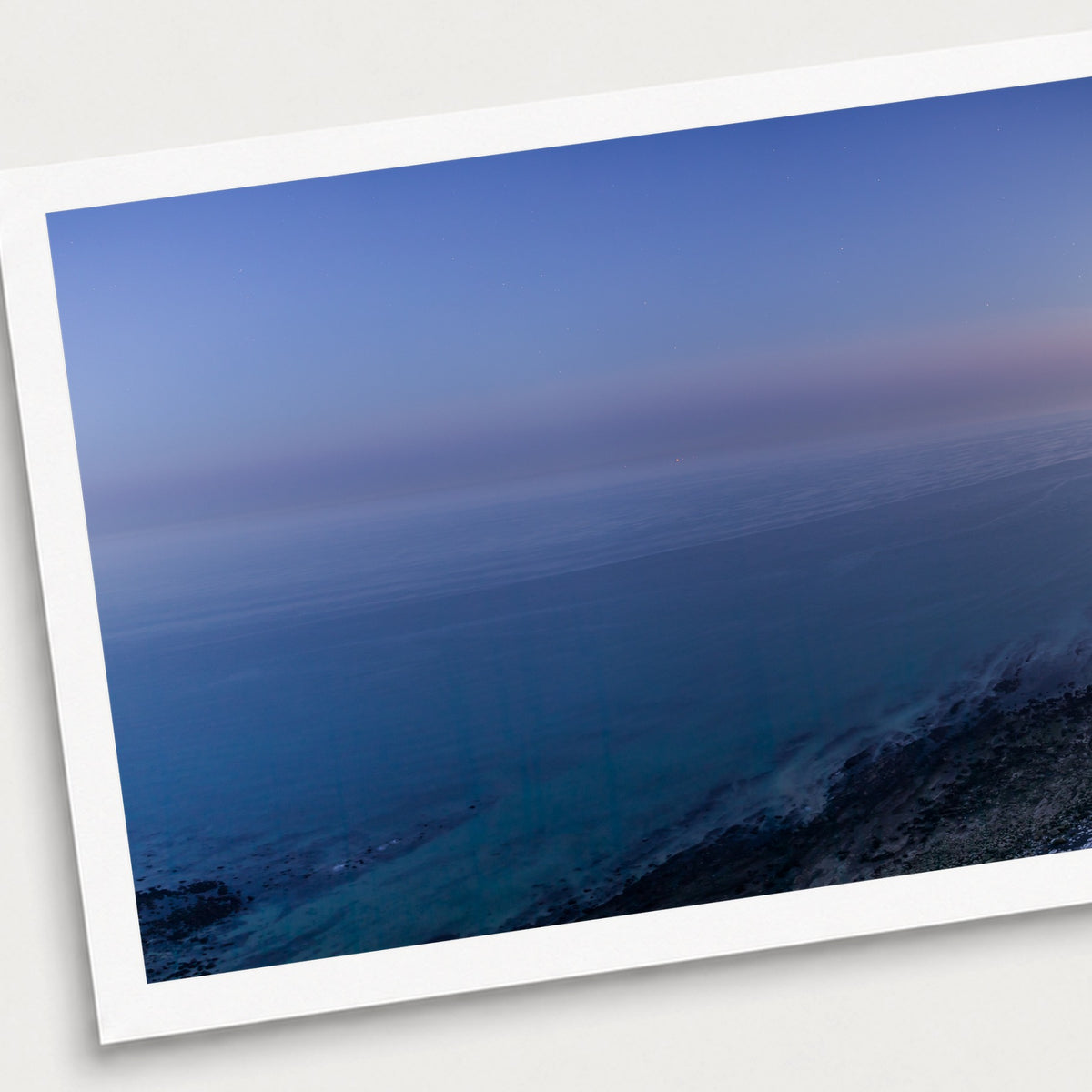 A photographic print of Beachy Head Moonrise, shown with a white border and angled presentation on a light background.