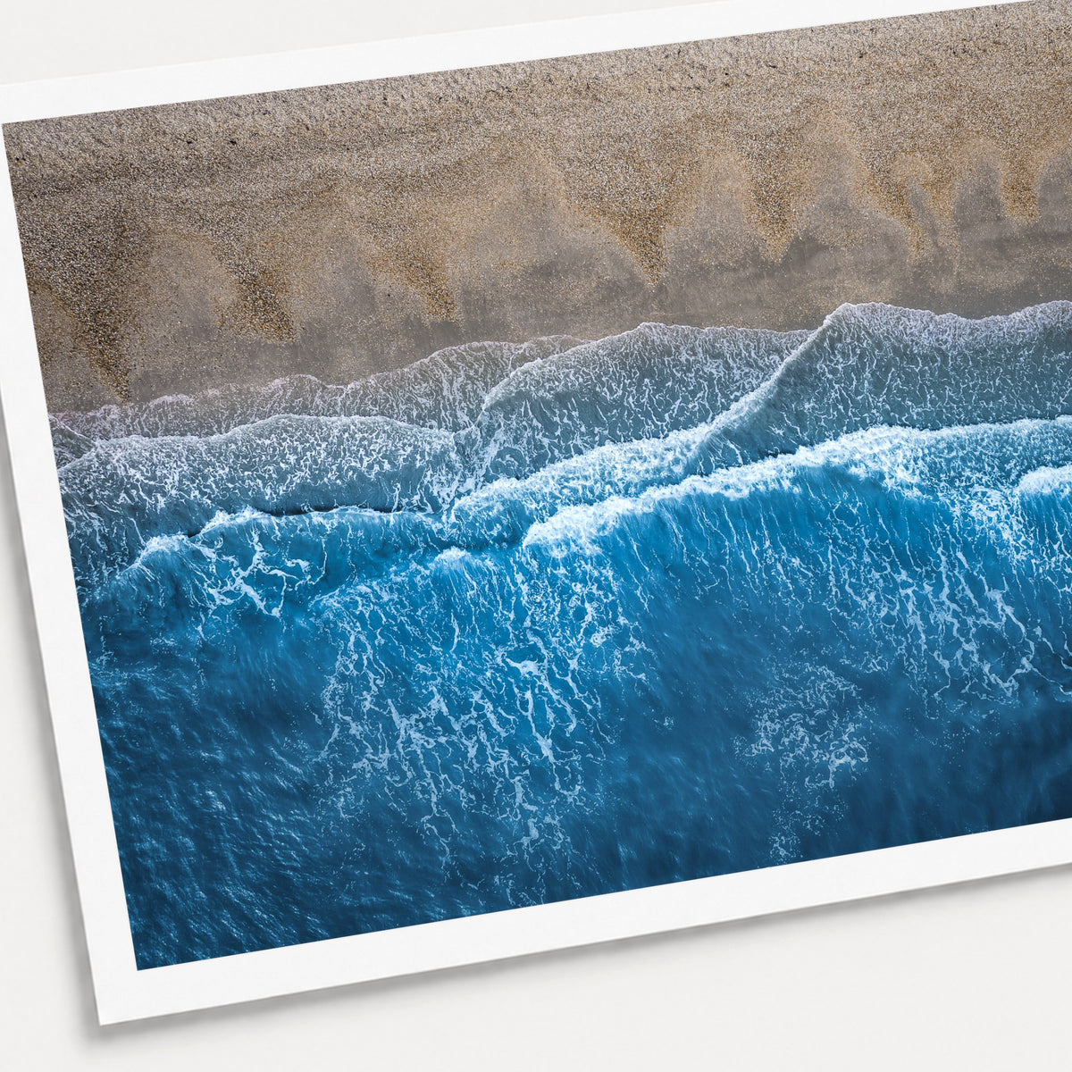 A photographic print of Breaking Blue, shown with a white border and angled presentation on a light background.