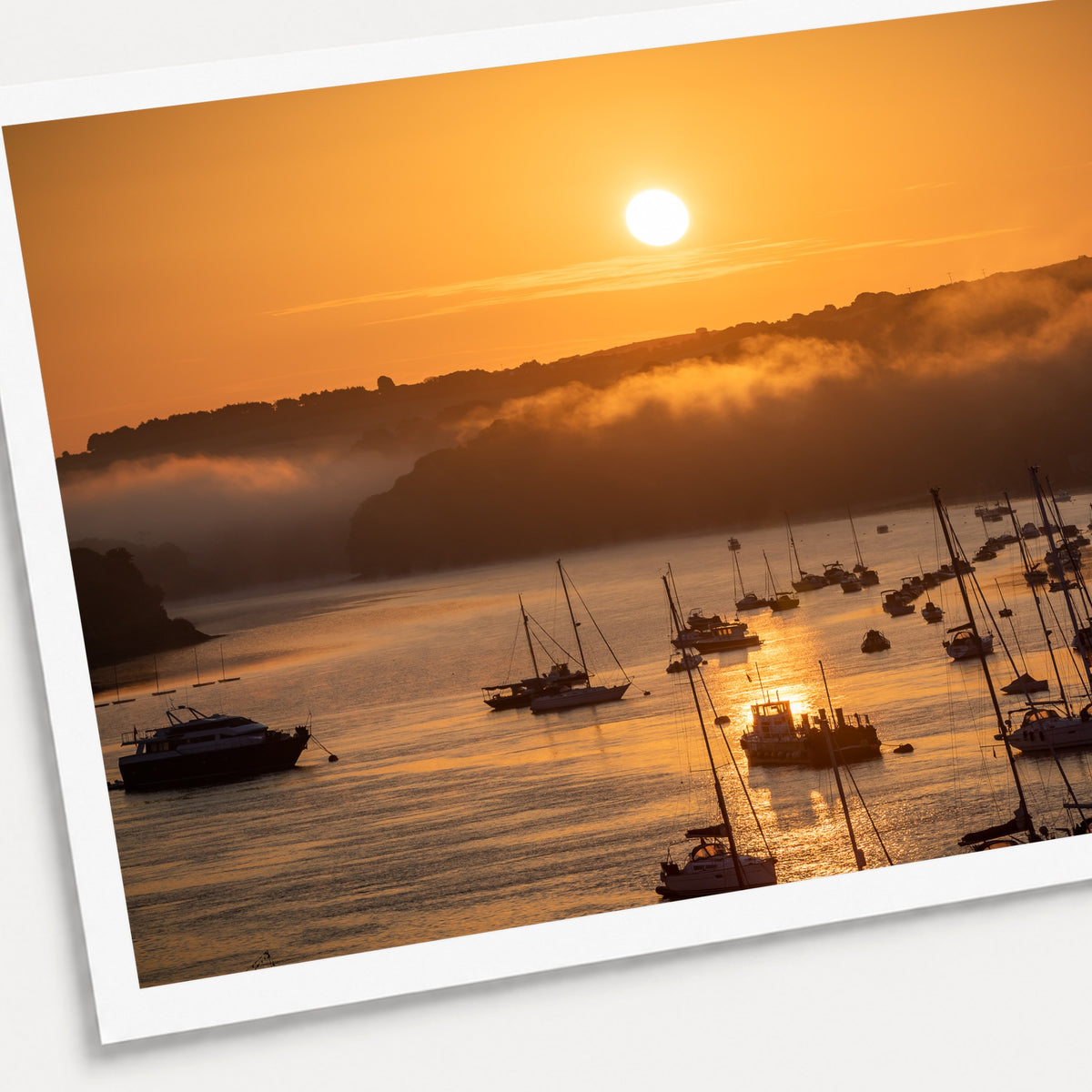 A photographic print of Harbour Sunrise, shown with a white border and angled presentation on a light background.