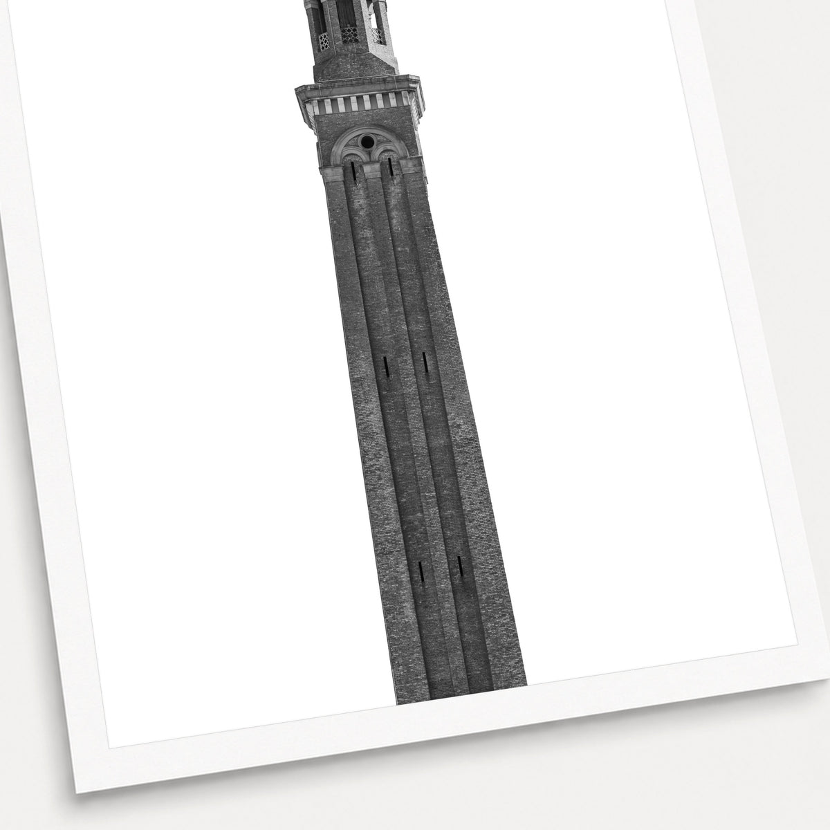 A black and white photographic print of The Water Tower, shown with a white border and angled presentation on a light background.