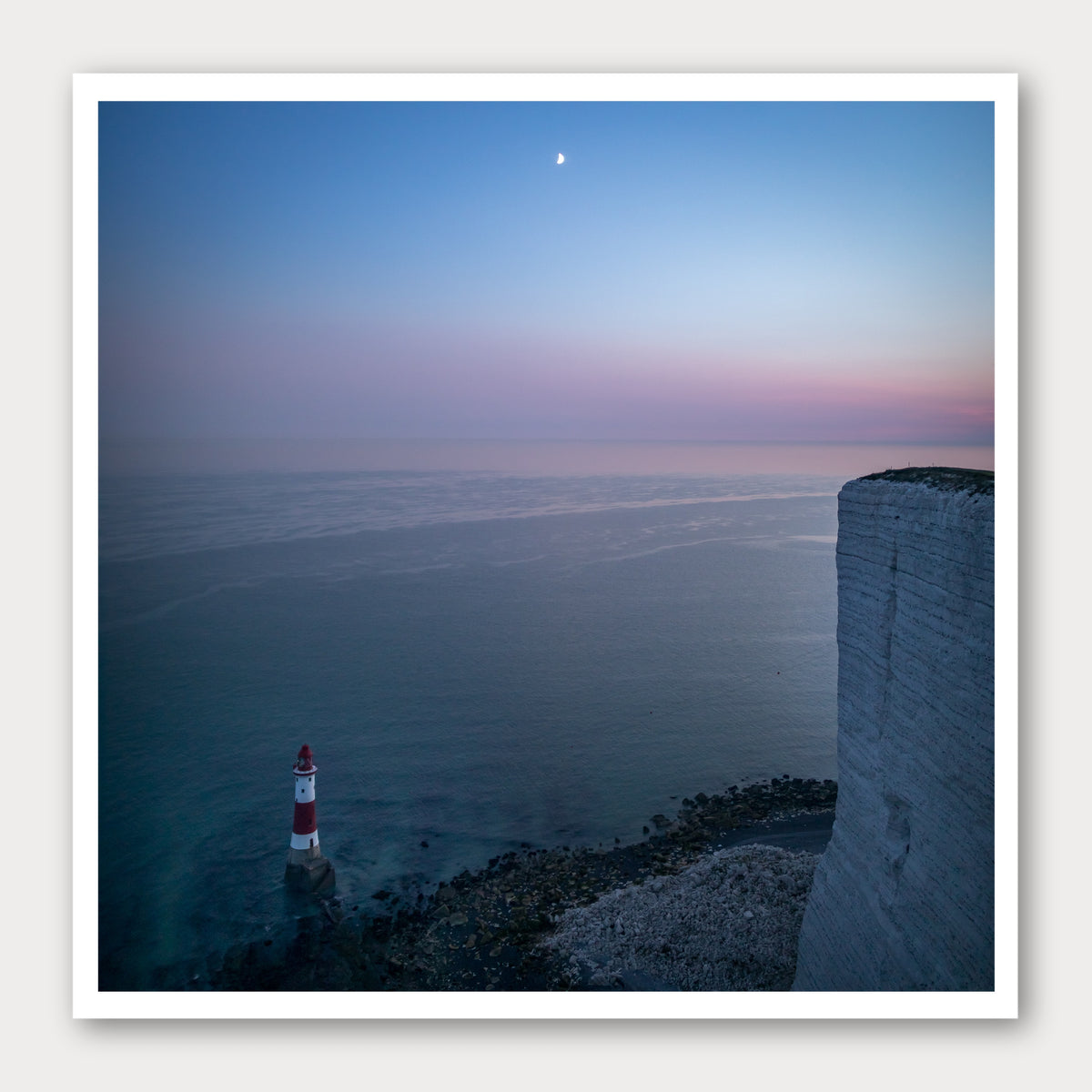 A photographic print of Beachy Head by Night, framed with a white border and shown against a light gray background.
