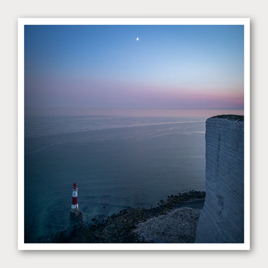 A photographic print of Beachy Head by Night, framed with a white border and shown against a light gray background.