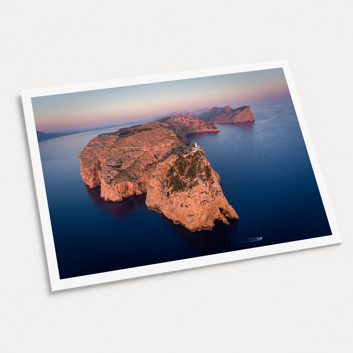A photographic art print of Cap De Formentor, displayed at an angle on a light gray background.