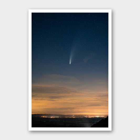 A photographic print of Comet Neowise, framed with a white border and shown against a light gray background.