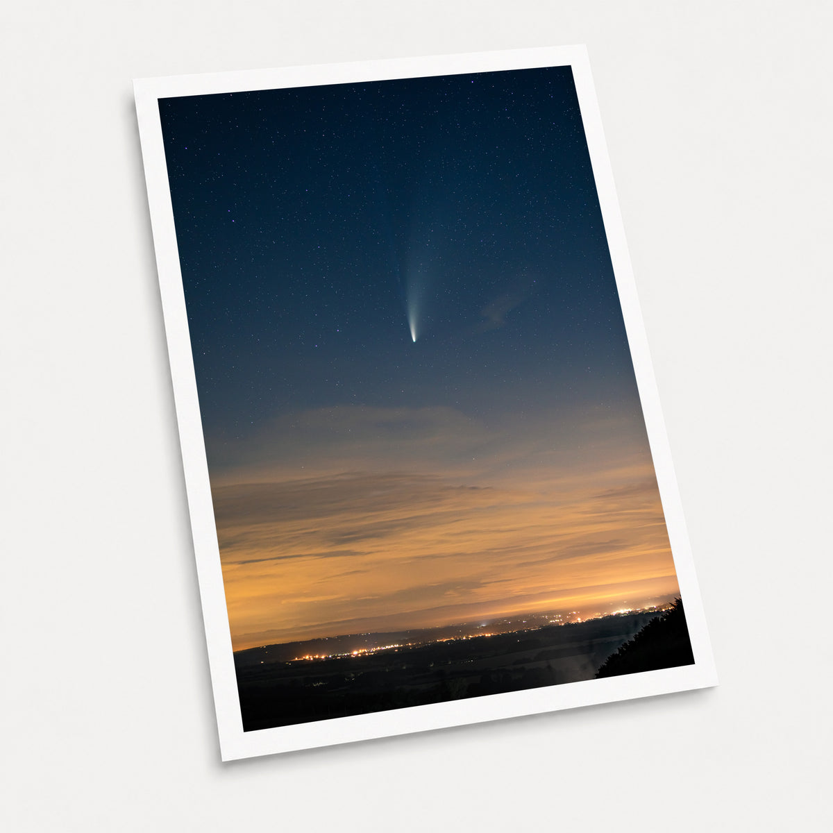 A photographic art print of Comet Neowise, displayed at an angle on a light gray background.