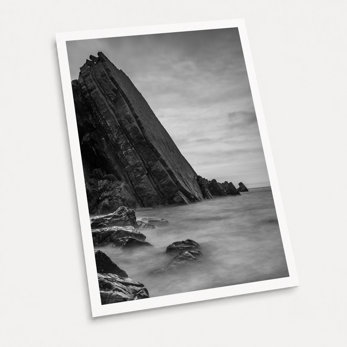 A black and white photographic art print of Dragon's Back, displayed at an angle on a light gray background.