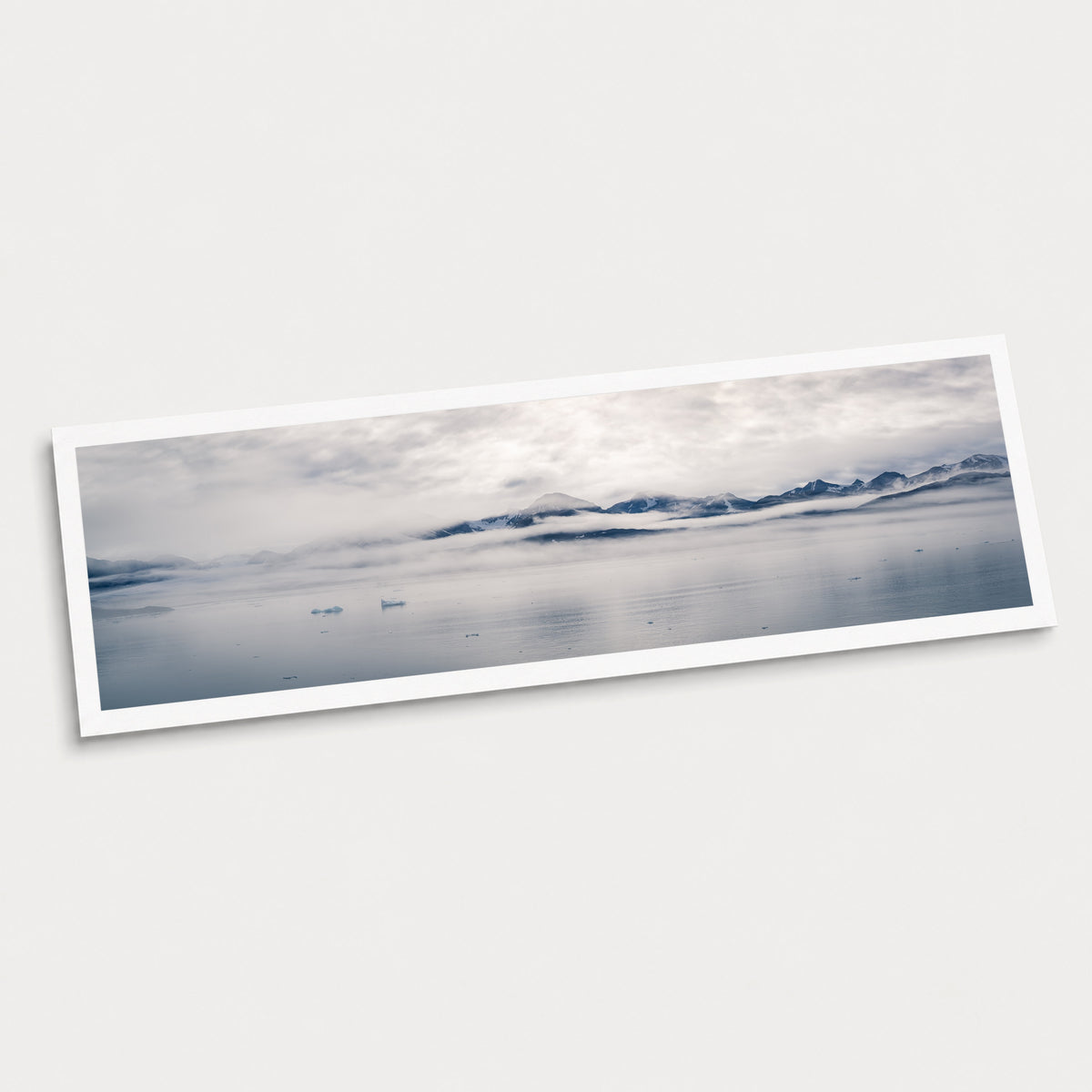 A photographic art print of Glacial Waters, displayed at an angle on a light gray background.