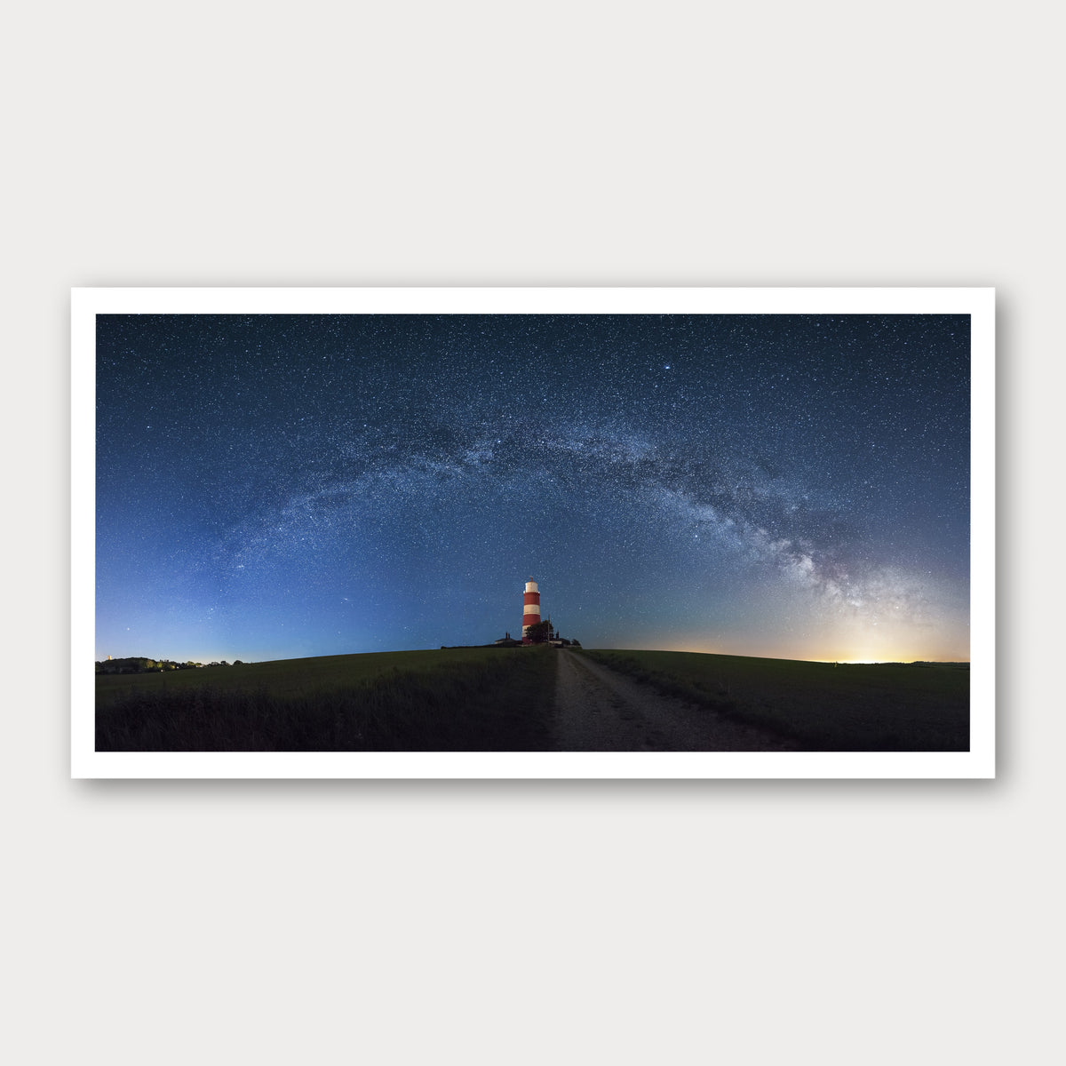 A photographic print of Happisburgh Lighthouse Milky Way, framed with a white border and shown against a light gray background.