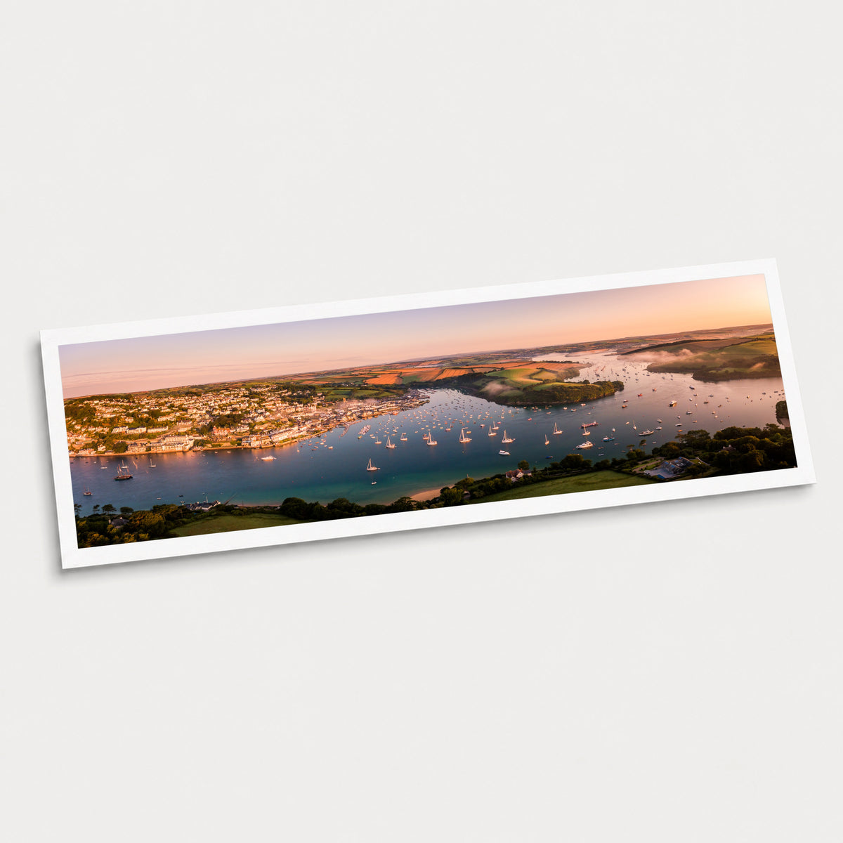 A photographic art print of Harbour Light, displayed at an angle on a light gray background.