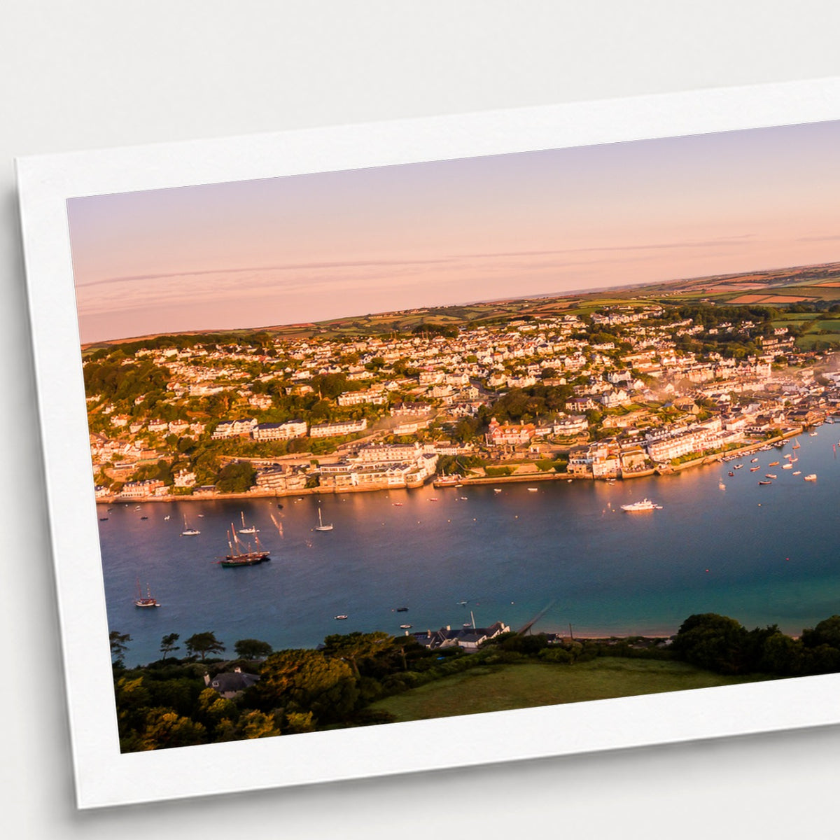 A photographic print of Harbour Light, shown with a white border and angled presentation on a light background.