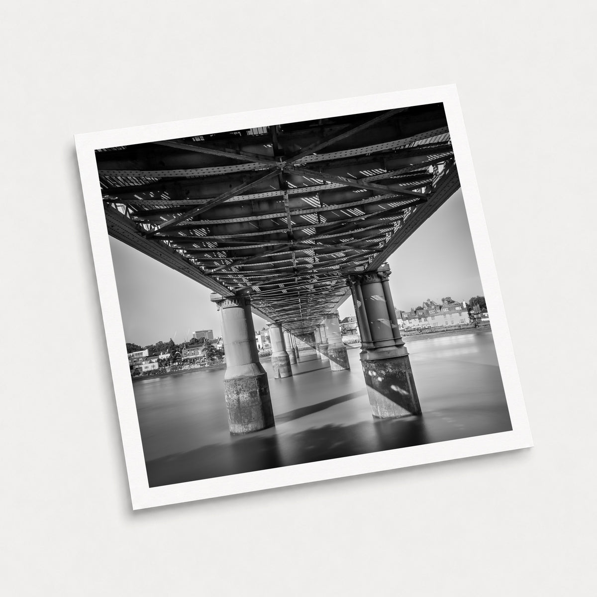 A photographic art print of Kew Railway Bridge, displayed at an angle on a light gray background.