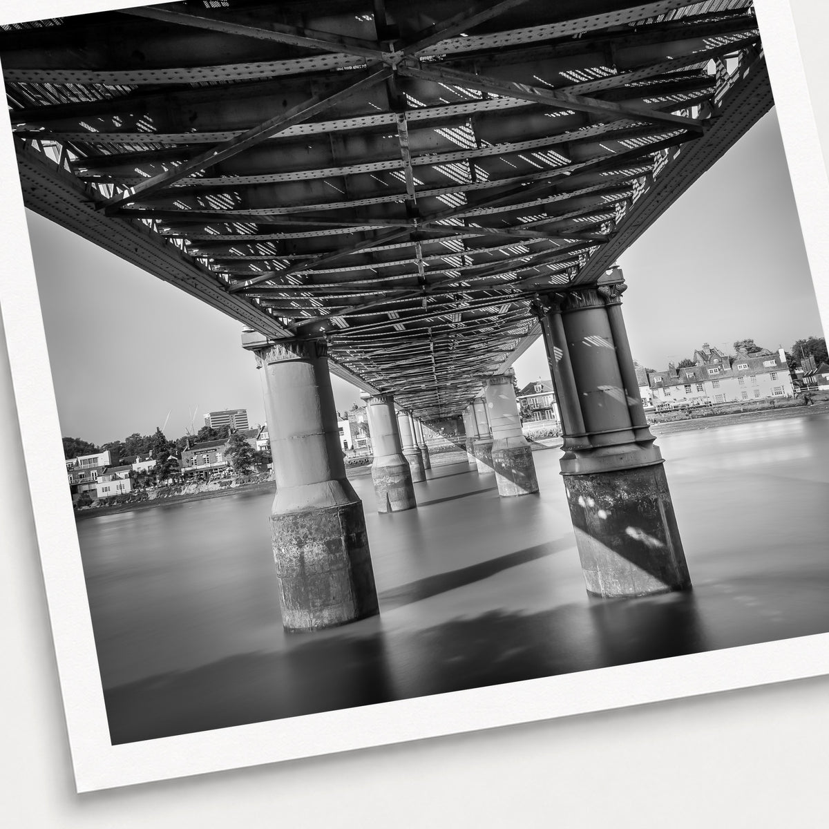 A photographic print of Kew Railway Bridge, shown with a white border and angled presentation on a light background.