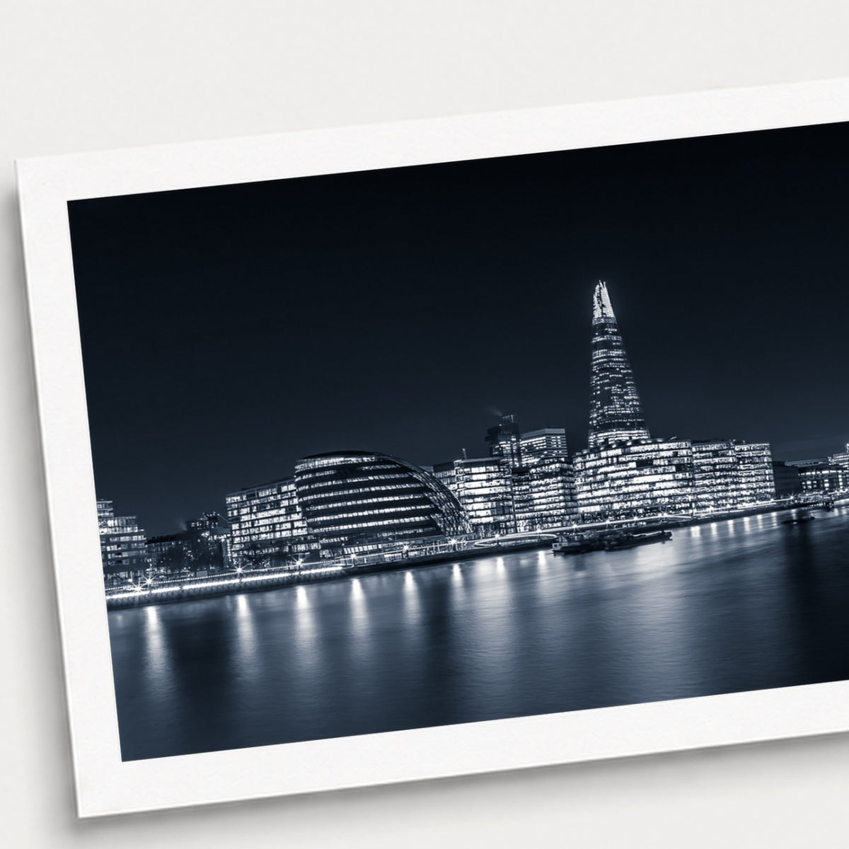 A photographic print of London Illuminated, shown with a white border and angled presentation on a light background.