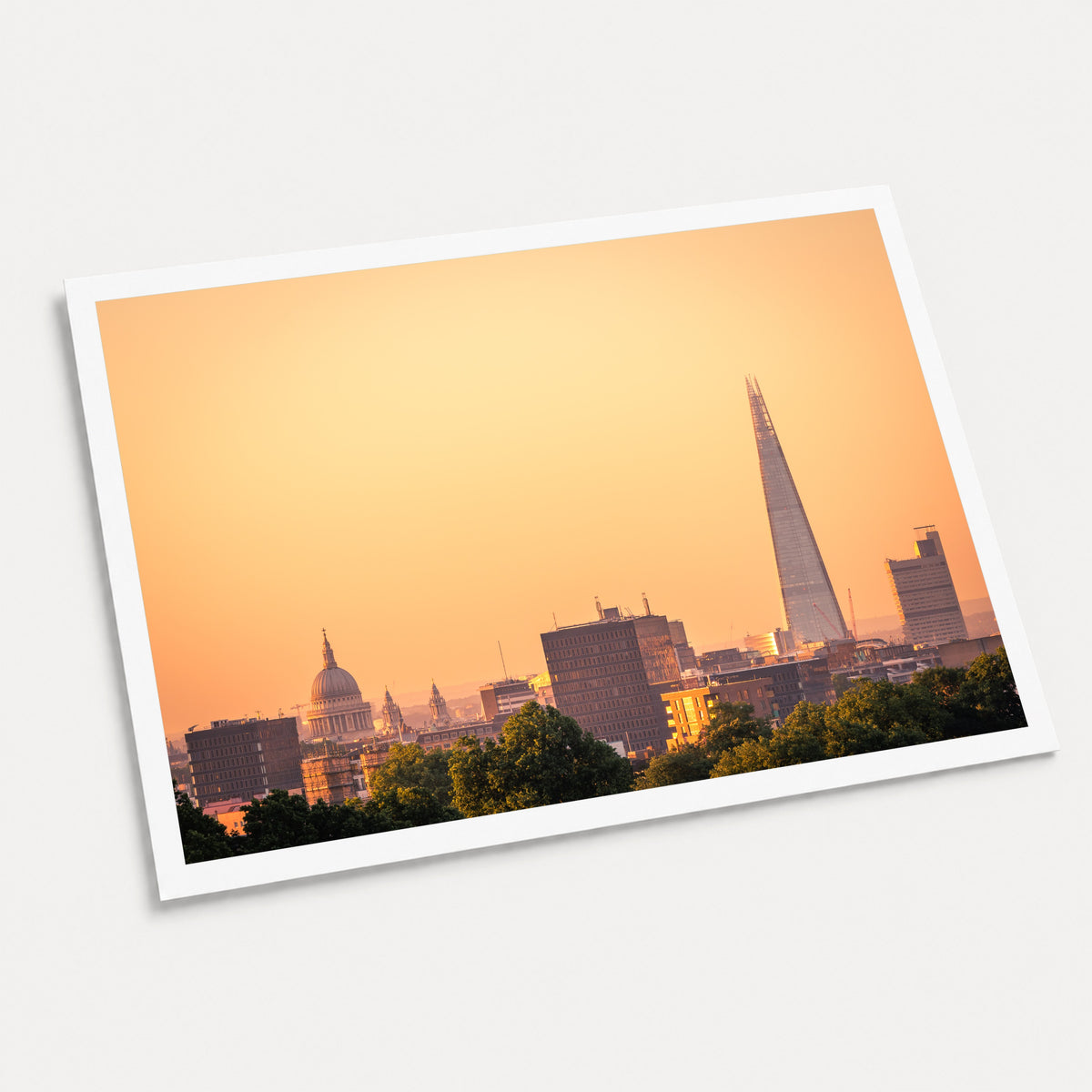 A photographic art print of London Sunrises, displayed at an angle on a light gray background.