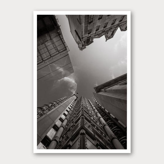 A black and white photographic print of Looking up at Lloyds, framed with a white border and shown against a light gray background.