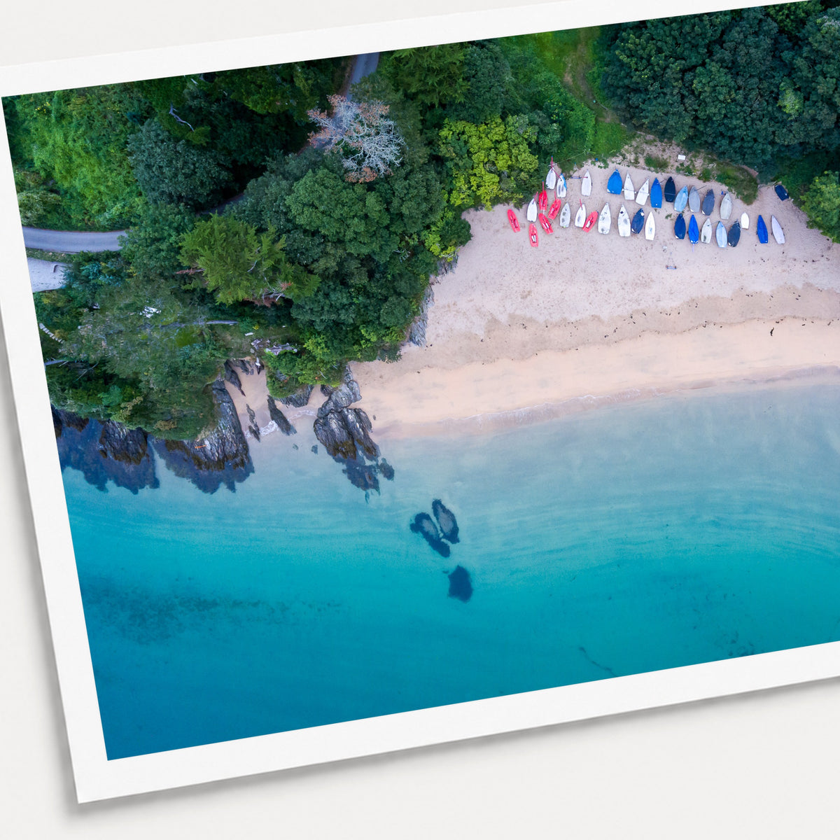 A photographic print of Mill Bay, shown with a white border and angled presentation on a light background.