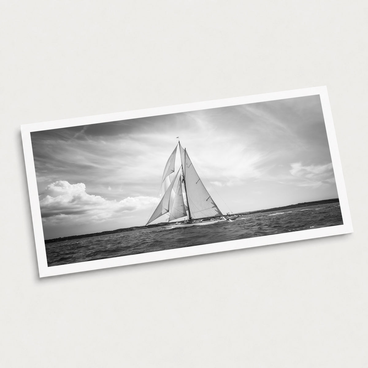 A black and white photographic art print of Plain Sailing, displayed at an angle on a light gray background.
