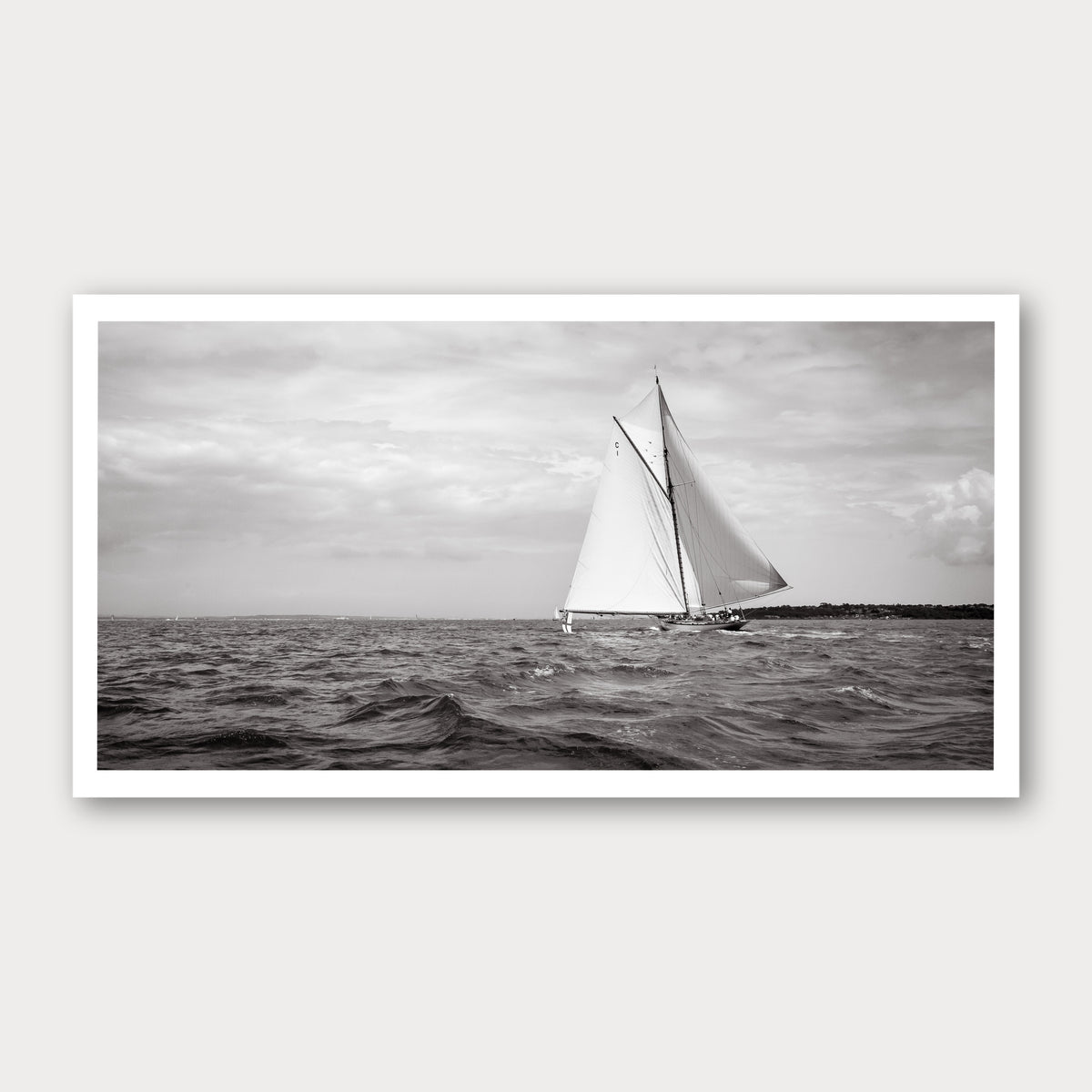 A black and white photographic print of Sail Away, framed with a white border and shown against a light gray background.