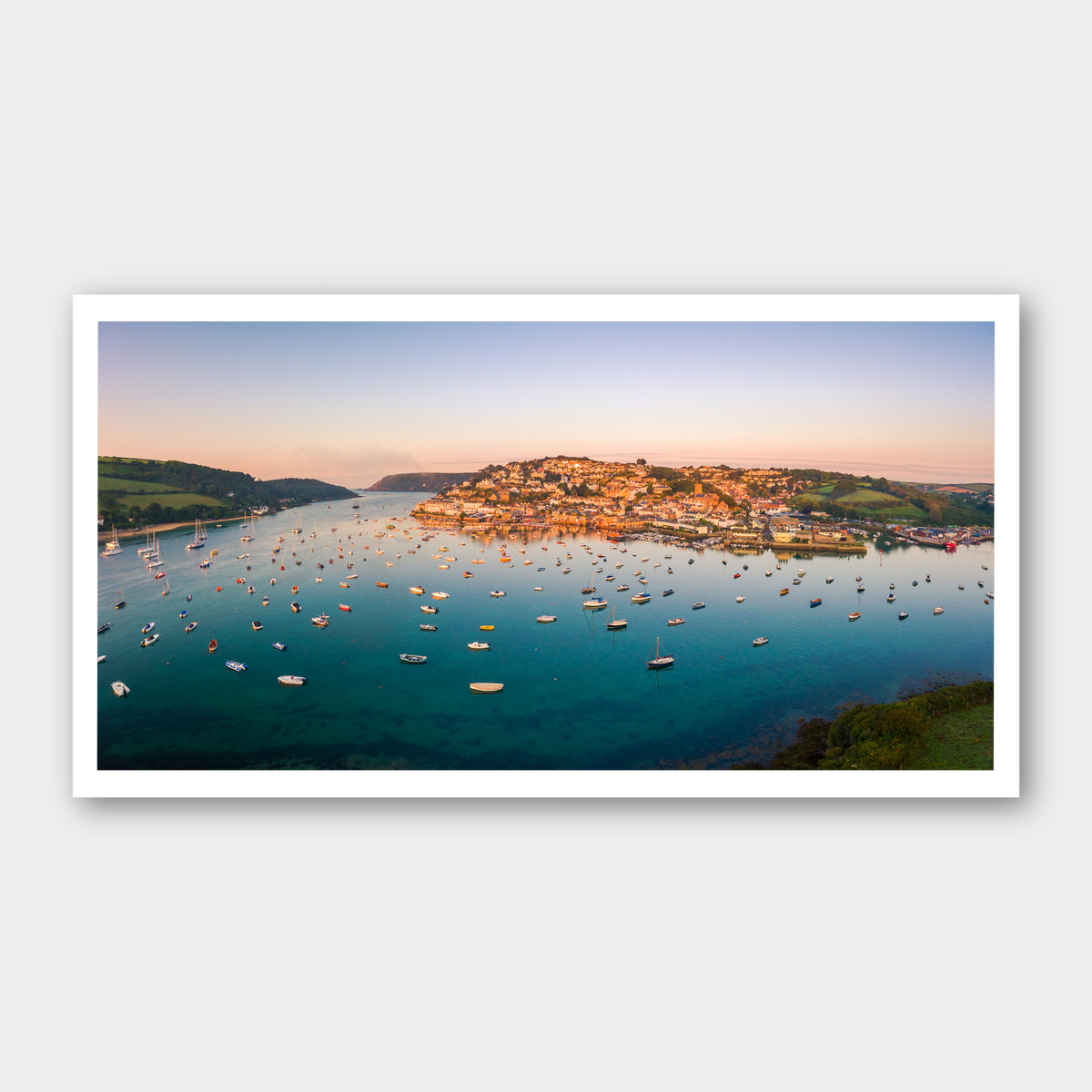 A photographic print of Salcombe Sunrise, framed with a white border and shown against a light gray background.