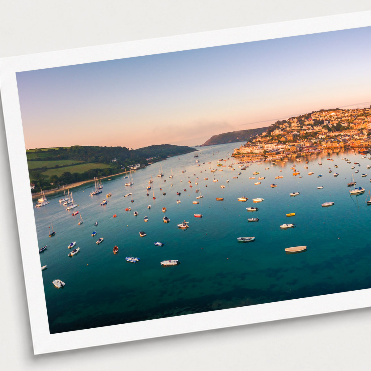 A photographic print of Salcombe Sunrise, shown with a white border and angled presentation on a light background.