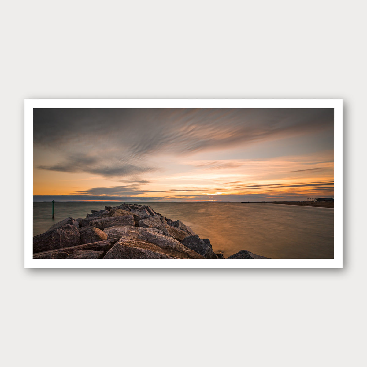 A photographic print of Seascape Sunset, framed with a white border and shown against a light gray background.