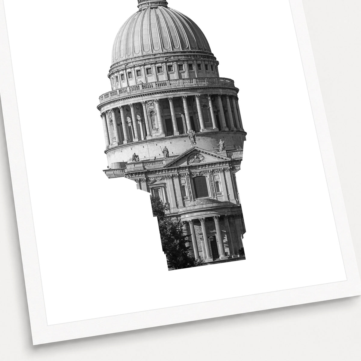 A black and white photographic print of St Paul's Cathedral, shown with a white border and angled presentation on a light background.