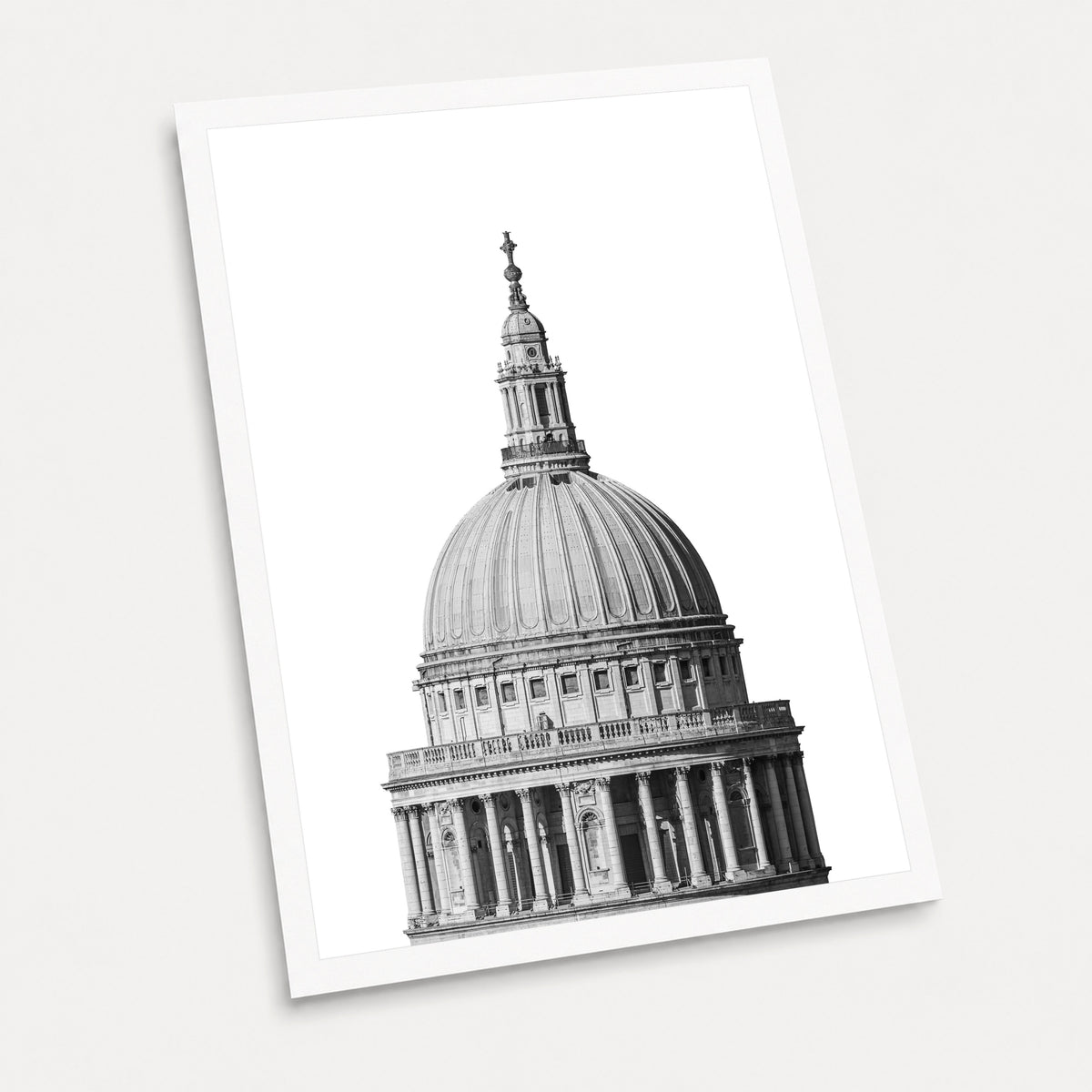 A black and white photographic art print of St Paul's Cathedral, displayed at an angle on a light gray background.