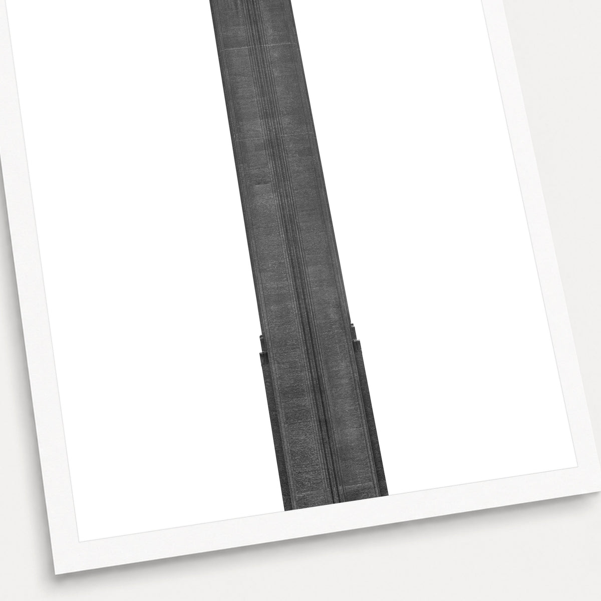 A black and white photographic print of Tate Modern, shown with a white border and angled presentation on a light background.