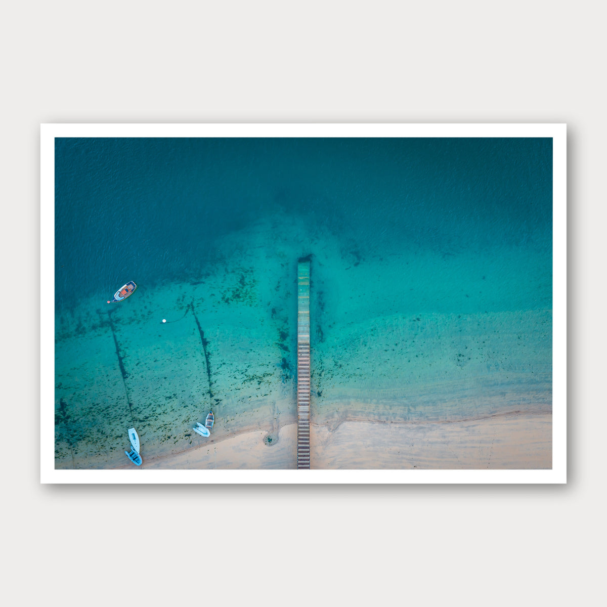 A photographic print of The Jetty, framed with a white border and shown against a light gray background.