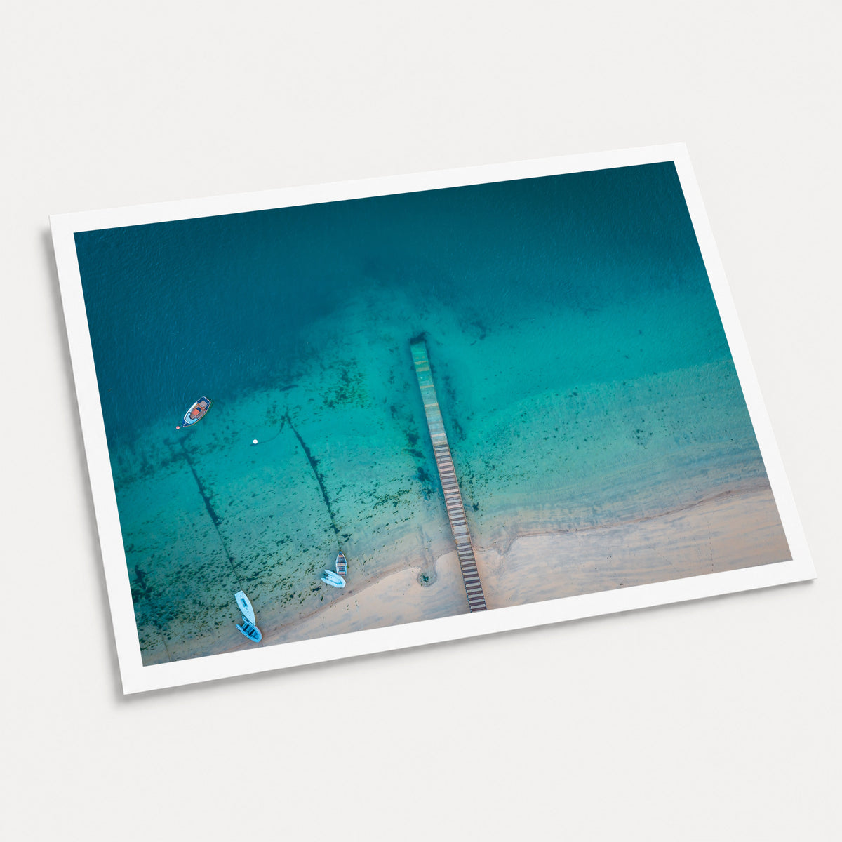 A photographic art print of The Jetty, displayed at an angle on a light gray background.