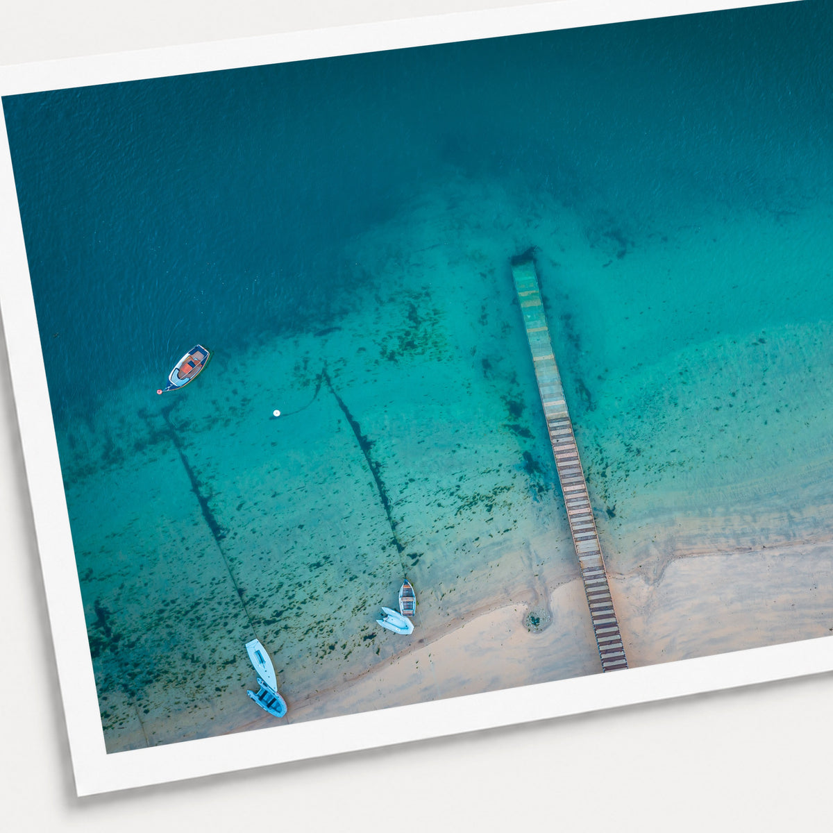 A photographic print of The Jetty, shown with a white border and angled presentation on a light background.