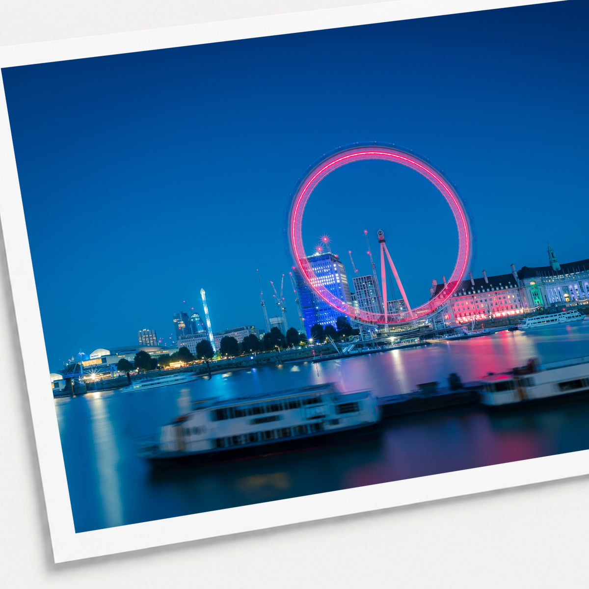 A photographic print of The London Eye, shown with a white border and angled presentation on a light background.