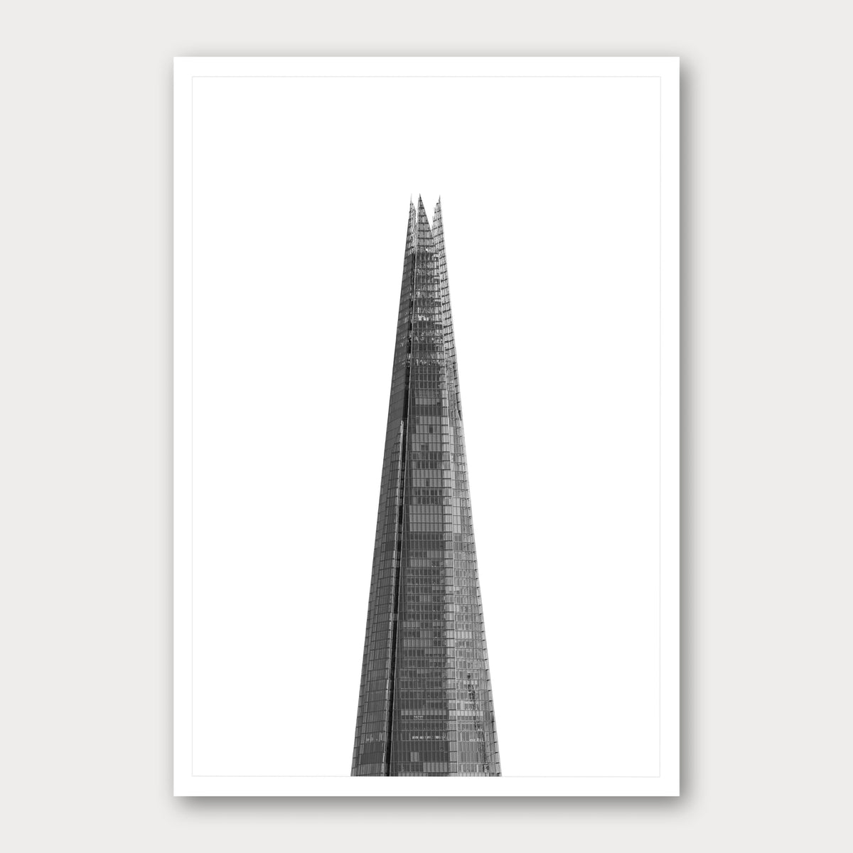 A black and white photographic print of The Shard, framed with a white border and shown against a light gray background.