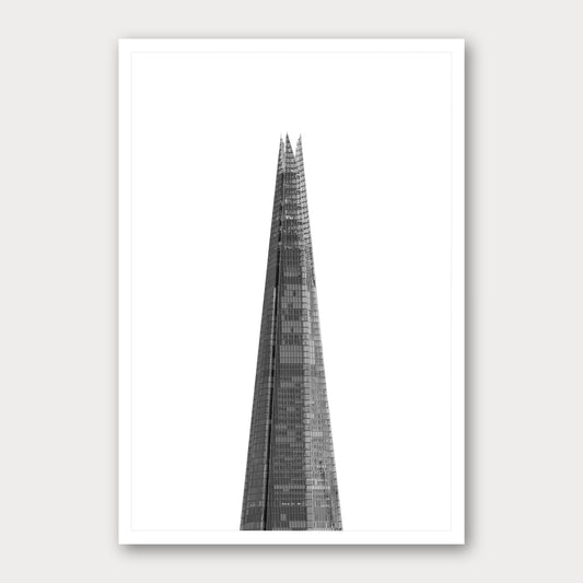 A black and white photographic print of The Shard, framed with a white border and shown against a light gray background.