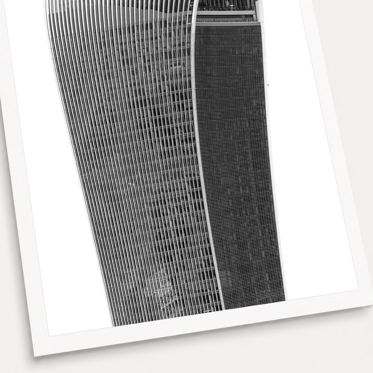 A black and white photographic print of The Walkie Talkie, shown with a white border and angled presentation on a light background.