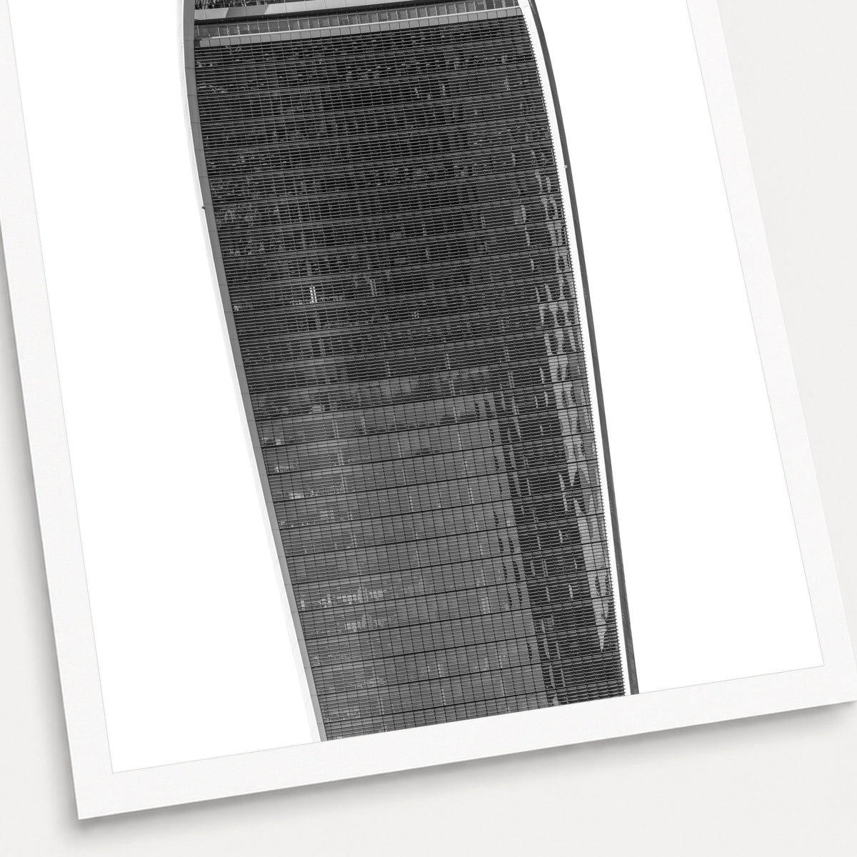A black and white photographic print of The Walkie Talkie, shown with a white border and angled presentation on a light background.