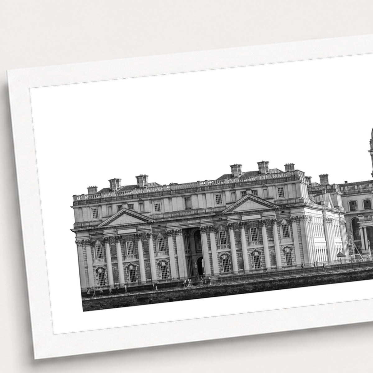 A black and white photographic print of University of Greenwich, shown with a white border and angled presentation on a light background.